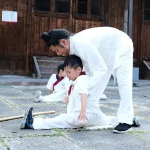 A Tai Chi teacher correcting a student's posture